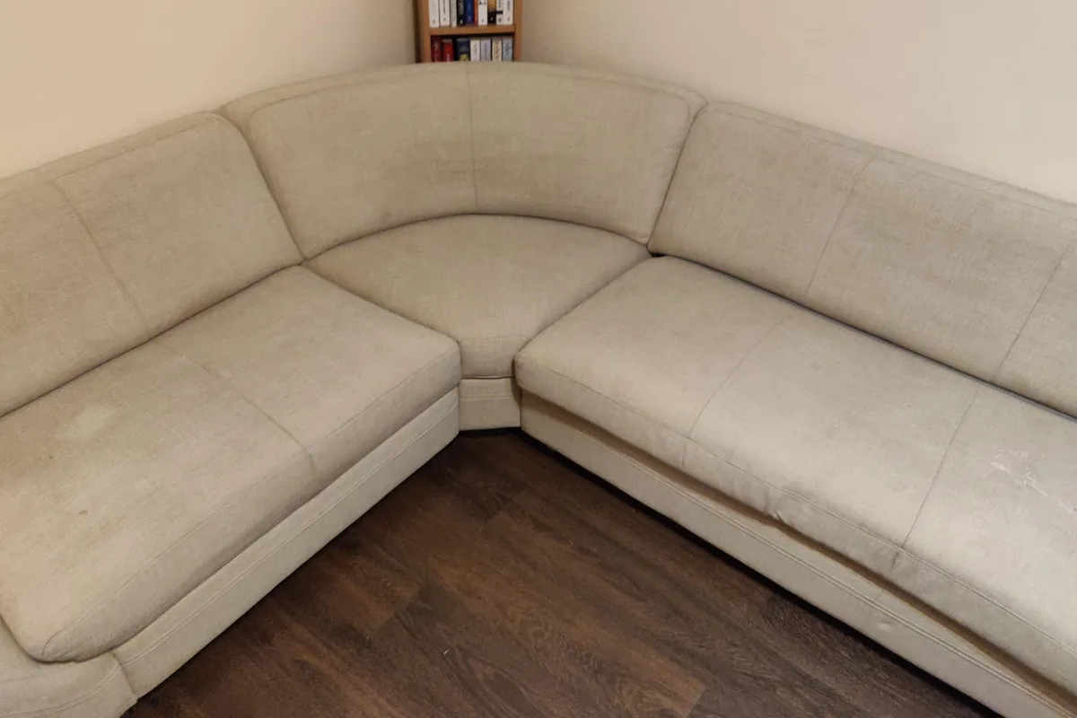 Beige corner lounge, heavy soiling along both seat runs — after cleaning by SevenClean