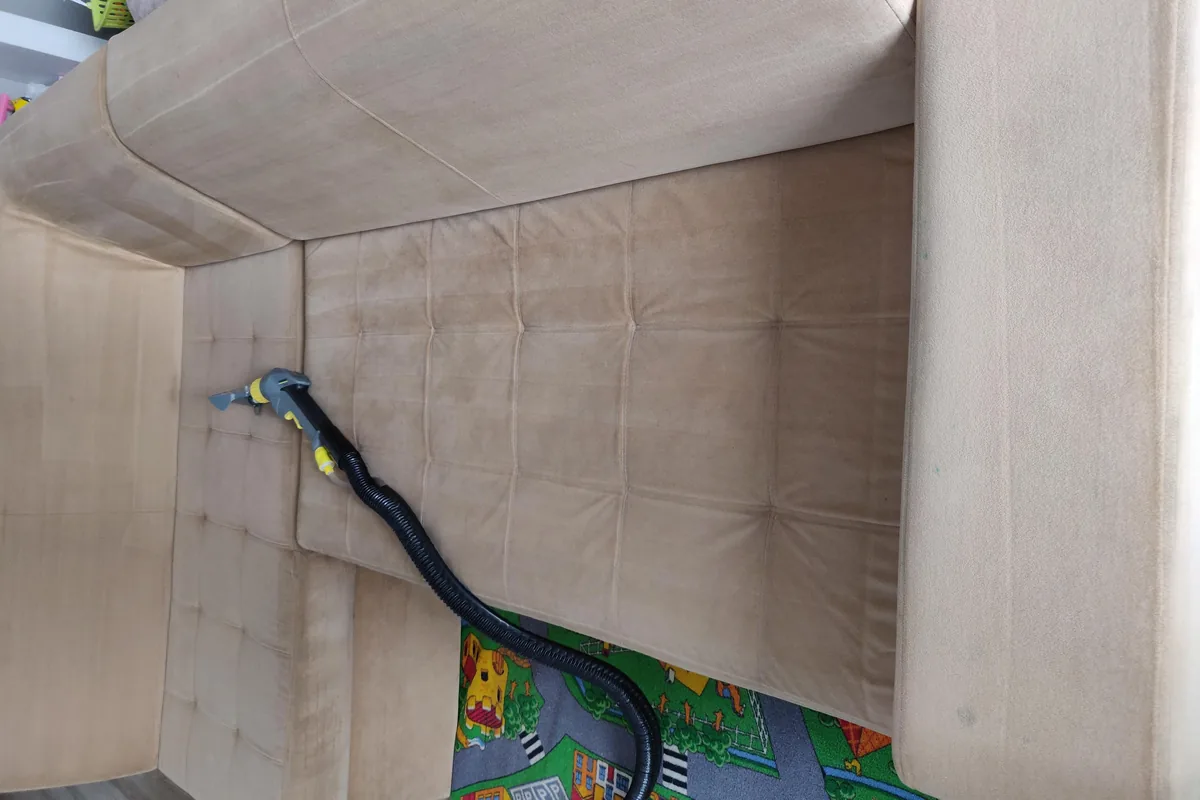 Sofa seat and back covered in dark grey soiling — after cleaning by SevenClean