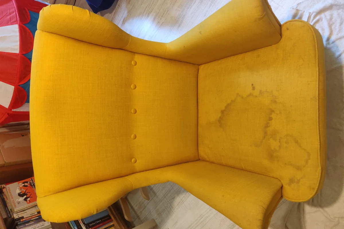 Yellow armchair with a spill mark on the seat — before cleaning