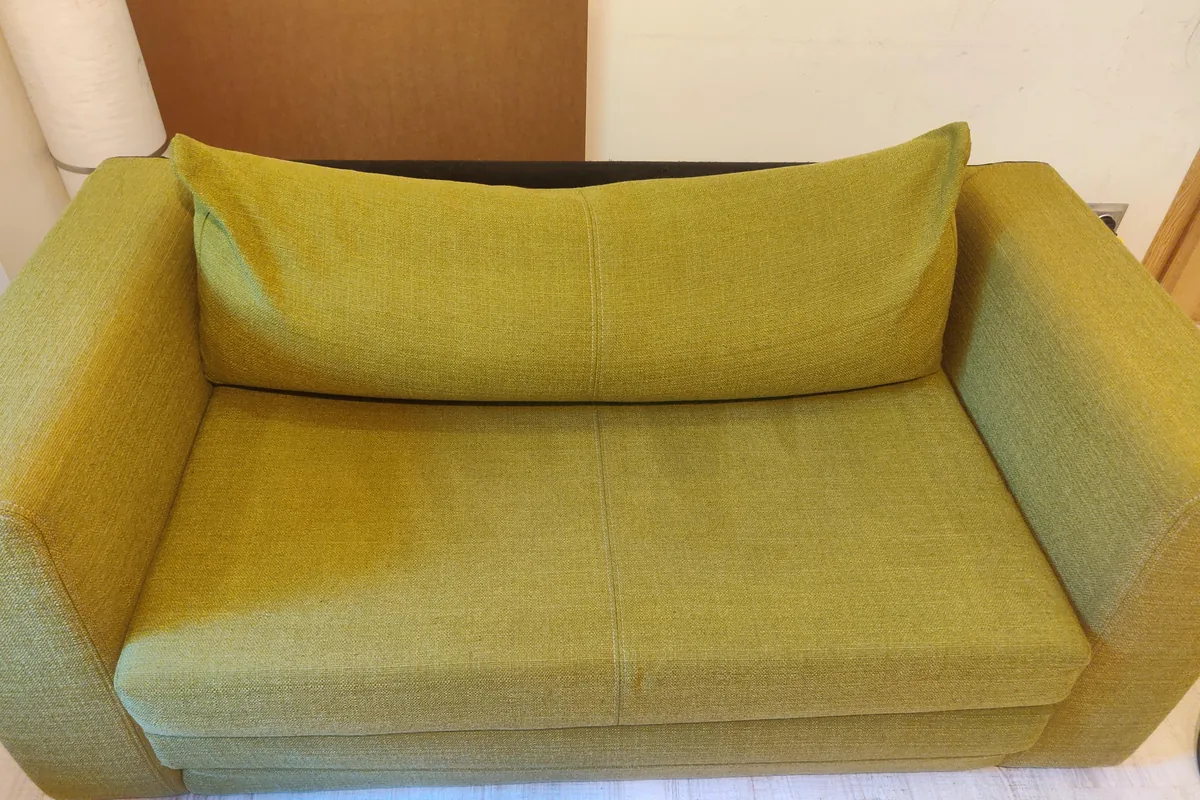 Olive green sofa bed, marks across the seat — after cleaning by SevenClean