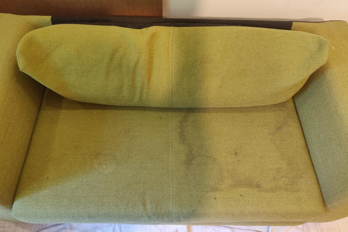 Olive green sofa bed, marks across the seat — before cleaning