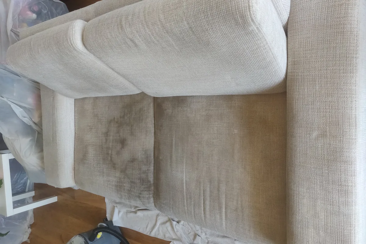 Cream armchair, grey soiling on the seat and back — before cleaning