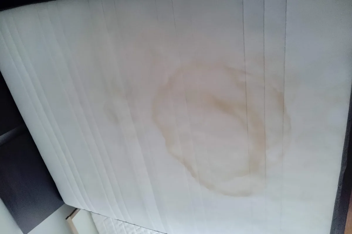 Mattress with a large brown ring stain, before cleaning