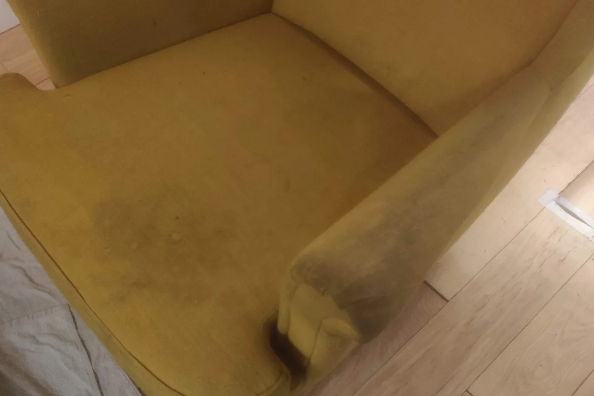 Mustard armchair, soiling on the seat and arm — before cleaning