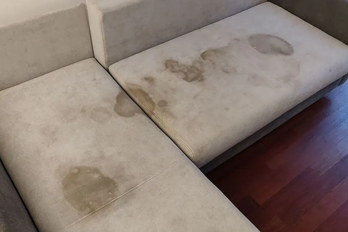 Grey sofa with spill stains on the chaise — before cleaning