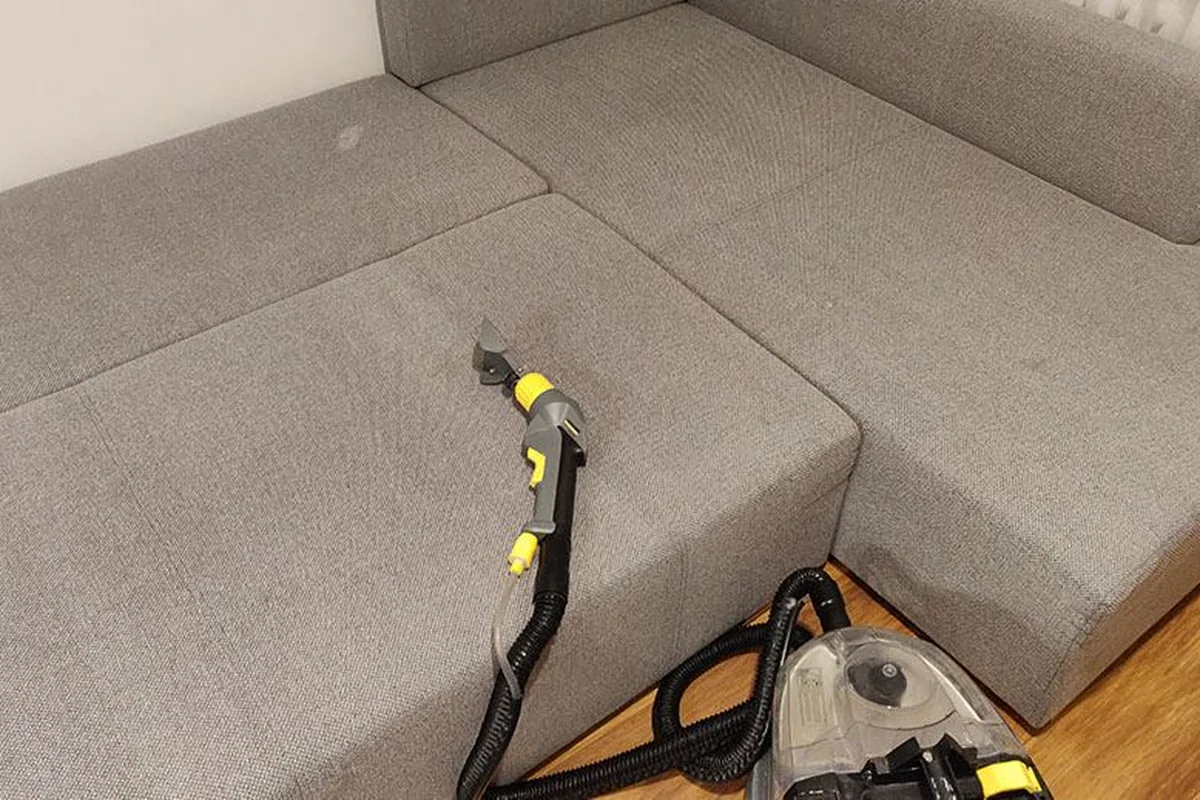 Corner lounge with a dark spill on the seat — after cleaning by SevenClean